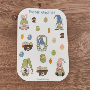 A sheet of Easter-themed stickers featuring gnomes, Easter eggs, carrots, and bunnies. The sticker sheet features pastel green, blue, and pink.