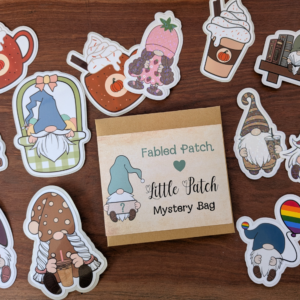 A brown envelope that reads "Little Patch Mystery Bag." A pile of gnome stickers surrounds the envelope.