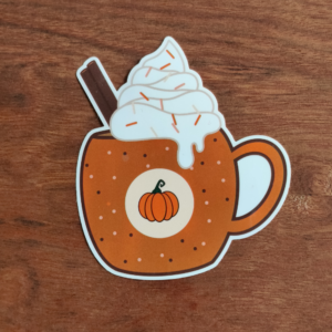 A sticker featuring a pumpkin spice latte. The orange mug is dotted with white circles and topped with whipped cream and sprinkles. A cinnamon stick sits in the drink, and a pumpkin sits in the center.