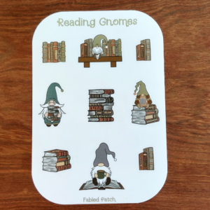 A sticker sheet featuring illustrations of reading gnomes. The gnomes are depicted with books, some holding stacks of books, others reading. The color palette includes greens, browns, and tans.