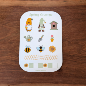 A spring gnome sticker sheet featuring 2 gnomes, a birdhouse, garden tools, and bees. The sticker sheet contains yellow, green, and pink colors.