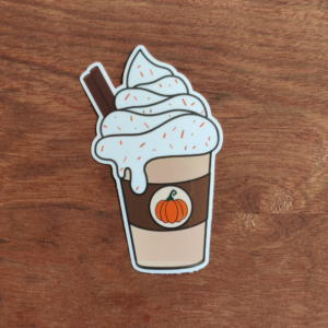 A sticker featuring a pumpkin spice latte design. The latte has a whipped cream topping with orange sprinkles and a cinnamon stick. A brown cup with a pumpkin graphic completes the design.